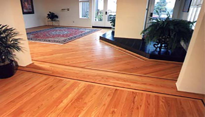 This large living room needed a special touch to match its spectacular view of SF Bay. Unexpected angularity and a discrete mahogany border did the trick.