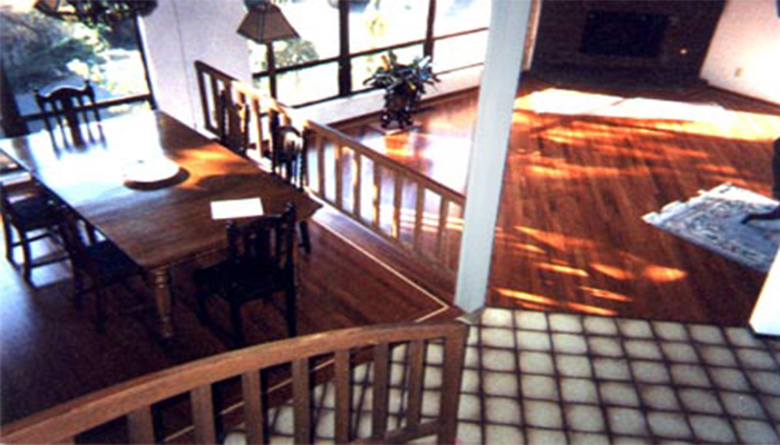 Solid Brazilian cherry installed diagonally adds sweeping elegance to this two-level living/dining room.