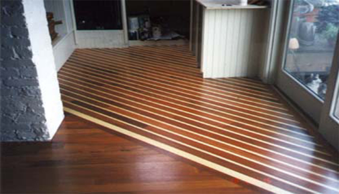A simulated boat deck of Brazilian cherry and maple in its kitchen echos this home's nautical decor.