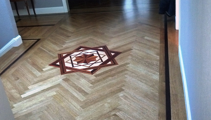 A single mahogany feature strip both sets off and accentuates the white oak herringbone design.